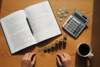 A flat lay of a desk showing the costs to self-publish a book